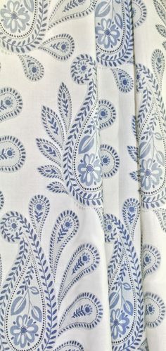 the fabric is blue and white with an intricate design on it's back side