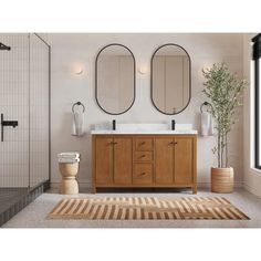 a bathroom with two mirrors above the sink and a rug on the floor next to it