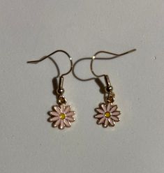 Welcome to my earring shop! When you BUY 3 PAIRS OF EARRINGS (any combination of styles) from my shop and pay for shipping for 3 pairs, you get A 4TH PAIR FOR FREE (of equal or lesser cost) with NO ADDITIONAL SHIPPING FEE! Select your three pairs and checkout as usual. Then message me which 4th (free) pair you would like and it will be added to your package. A pretty set of small daisy flower earrings in pale pink on nickel-free gold iron wires! There is a yellow center of the flower. These are Cute Gold Jewelry For Spring, Cute Gold Flower-shaped Earrings, Cute Flower Shaped Hypoallergenic Earrings, Cute Hypoallergenic Flower-shaped Earrings, Cute Flower Charm Earrings For Everyday, Cute Everyday Earrings With Flower Charm, Cute Gold Flower Charm Earrings, Cute Flower Shaped Jewelry With Matching Earrings, Cute Gold Flower Earrings For Spring