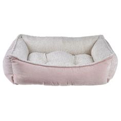 a dog bed that is pink and white