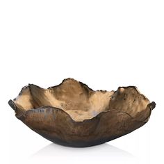 a wooden bowl sitting on top of a white table