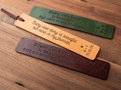 three leather bookmarks that say every love story is beautiful