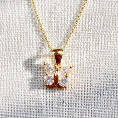 "This beautiful butterfly necklace is a must-have for any jewelry lover! Made from gold plated sterling silver, it's got a touch of sparkle with CZ stones on the butterfly pendant. The delicate chain adds a touch of sophistication, making it perfect for any occasion. Plus, it would make a great gift for someone special! This is a perfect for Mother's Day gift, Birthday gift, Valentine's Day gift, bridesmaid gift, graduation gift, Christmas gift, and gift for her. The necklace also comes with mat Gift For Anniversary, Necklace For Her, Gift Graduation, Delicate Chain, Gift For Birthday, Butterfly Necklace, Butterfly Pendant, Jewelry Lover, Beautiful Butterflies