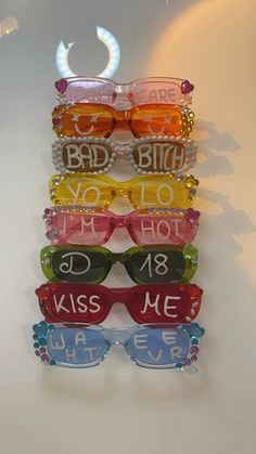 six pairs of sunglasses with words on them