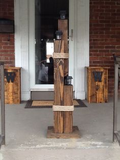 a tall wooden pole sitting on top of a sidewalk next to a building with windows