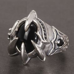 Cool Antique Paw Ring for Men - Pure 925 Silver with Natural Black Agate Stone Item Weight: 8.8g around Side Stone: Other Natural material Metal Stamp: 925 , Sterling Shape\pattern: Oval Setting Type: Prong Setting Style: Vintage Rings Type: Wedding Bands Occasion: Anniversary Certificate Type: NJQSIC Metals Type: Silver Main Stone: Agate Gender: Men Fine or Fashion: Fine Item Type: Rings Color: Silver Type: Vintage, Fashion, Punk, Rock Setting: Natural Onyx Style: Wedding Band, Party Position: Knuckle, Nail, Finger Weight: 8.8g around Warranty: 100% Real 925 Sterling Silver Stone Size: 1.3*1cm Make a bold statement with this cool antique paw ring for men. Made from pure 925 silver, this ring is not only stylish but also durable and long-lasting. The natural black agate stone adds a touch Lotr Jewelry, Agate Stone Jewelry, Afro Jewelry, Paw Ring, Black Agate Stone, Retro Hip Hop, Claw Ring, Dragon Claw, Dragon Ring