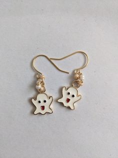 A cute and fun pair of ghost earrings, perfect for Halloween. The white enamelled ghost design, is on a 24k gold plated colour charm, attached to 24K gold plated ear wire hooks, with additional beads added. Great to keep as a fun pair of spooky, Halloween earrings, or to gift to ghost loving friend. Supplied in a gold organza pouch. White Spooky Earrings For Party, Spooky White Earrings For Party, Playful White Dangle Jewelry, Fun Nickel-free White Earrings, White Drop Earrings For Halloween, Novelty White Drop Earrings, Fun White Nickel-free Earrings, White Novelty Drop Earrings, White Novelty Dangle Jewelry