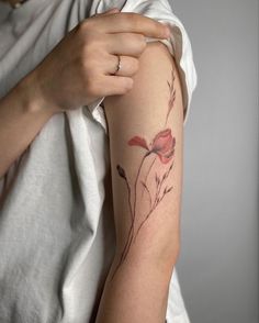 a woman with a flower tattoo on her arm