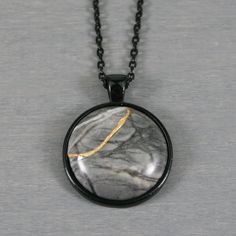 Kintsugi repaired Picasso jasper pendant in a black bezel setting on black chain Unique Black Necklace With Large Pendant, Black Minimalist Necklace With Large Pendant, Minimalist Black Necklace With Large Pendant, Black Necklace With Large Round Pendant, Unique Black Cabochon Necklace, Picasso Jasper, Jasper Pendant, Black Chain, Jasper Stone