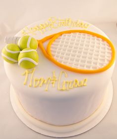 a cake with tennis rackets and balls on it