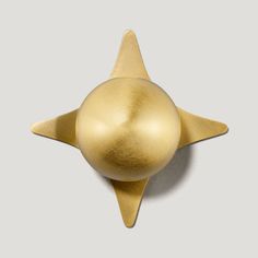 a gold star shaped object on a gray background