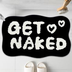 a bathroom rug that says get't naked on the floor next to white shoes