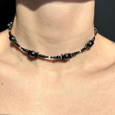 Handmade necklace made from natural hematite and synthetic cat's eye stone. This dark gray choker features glossy beads of hematite in various shapes and beads of cat's eye, completed with a stainless steel chain extender and closure. Thanks to the adjustable chain, the necklace can be worn higher or lower. If you need a different length for the accessory, please write to me about it. DIMENSIONS & FEATURES: ▪️ Materials: natural hematite stone, synthetic cat's eye stone, stainless steel (hypoallergenic and maintains its appearance over time) ▪️ Length: 35+10(chain extenders)=45 cm / 13,7+4(chain extenders)=17,7 inch ▪️ Color: dark gray ▪️ Weight: 23g / 0,8 oz PACKAGE & SHIPPING: ▪️ ECO-friendly packing. I draw inspiration from nature and strive to minimize environmental impact. ▪️ FREE shi Dark Beaded Necklace, Adjustable Hematite Necklace With Black Beads, Adjustable Hematite Beaded Necklaces, Adjustable Hematite Beaded Necklace, Adjustable Beaded Hematite Necklaces, Cat Eye Necklace, Linen Pouch, Galaxy Necklace, Choker Handmade