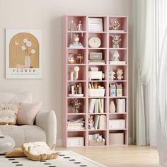 a living room filled with furniture and a book shelf next to a white couch on top of a hard wood floor