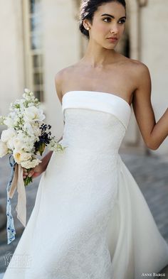 a woman in a white dress holding a bouquet