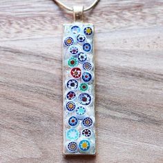 "These unique rectangle shaped pendants have been hand-crafted with genuine Italian Millefiori glass, where beautiful glass has been produced for centuries. The glass is set in a silver tray and sealed with high quality resin to produce an one of a kind pendant. Design: Italian Millefiori Glass Colour: Multiple Pendant Size: 5 x 1.5cm Chain Length: Choice of 16\" - 22\" silver plated snake chain" Modern Rectangular Glass Jewelry, Rectangular Glass Jewelry Gift, Rectangular Glass Jewelry For Gifts, Handmade Rectangular Glass Jewelry, Handmade Clear Rectangular Jewelry, Rose Quartz Pendant, Pendant Design, Quartz Pendant, Quartz Necklace