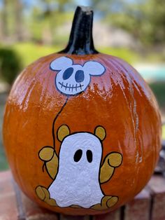 a painted pumpkin with a skeleton on it