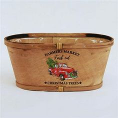 a wooden basket with a christmas tree on the front and bottom is decorated with an image of a red truck