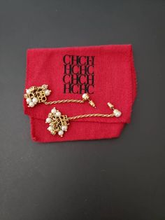 "This is a beautiful pair of Carolina Herrera pierced earrings. They feature a gold chain with Faux pearls. MEASUREMENTS: approx. 2 1/4\" (5.6 cm) x 1\" (2.5 cm) SIGNATURE: CH logo red pouch CONDITION: They are in gently used vintage condition with no issues . Take a look at my other items http://www.etsy.com/shop/Jewelrin" Elegant Gold Earrings With Logo Charm, Elegant Dangle Jewelry With Logo Charm, Frog Pins, Bezel Necklace, Faux Pearl Earrings, Butterfly Brooch, Fashion Logo, Pierced Earrings, Carolina Herrera