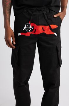 An embroidered Running Dog icon leaps across prime real estate on a pair of cargo pants that are made of sturdy cotton and topped with elastic for a comfortable, easy-moving fit. Elastic/drawstring waist Front slant pockets; cargo flap-bellows pockets Drawstring cuffs 100% cotton Machine wash, tumble dry Imported Black Owned/Founded Cotton Sweatpants With Patch Pockets For Streetwear, Sporty Cotton Parachute Pants With Patch Pockets, Sporty Cotton Cargo Pants With Patch Pockets, Black Cotton Cargo Jeans With Patch Pockets, Sporty Cotton Cargo Jeans With Multiple Pockets, Sporty Cotton Cargo Pants With Pockets, Sporty Cotton Pants With Patch Pockets, Black Cotton Utility Sweatpants, Casual Cotton Pants With Embroidered Logo