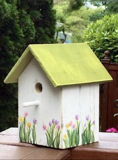 a bird house painted with flowers on it