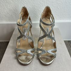 Jimmy Choo Leslie 110 Silver Heel Sandal With Zipper In The Back. Silver Glitter With Silver Chrome On Heel. Heel Tips Are Nearly Brand New. Worn Only Once For My Wedding. Luxury Sparkling Open Toe Heels, Sparkling Round Toe Heels For Cocktail, Designer Wedding Shoes With Heel Strap, Designer Sparkling High Heels, Designer Sparkling Heels For Party, Silver Heel, Shoes Silver, Jimmy Choo Heels, Silver Chrome