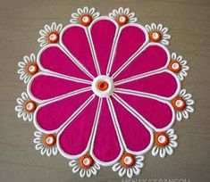 a pink and white flower with orange accents