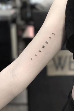 a person with a tattoo on their arm that says, phases of the moon tattoo i tumbr