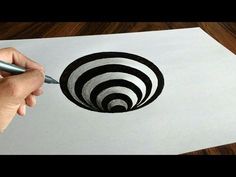 someone is drawing an optical illusion on paper