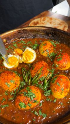 an iron pan filled with eggs and sauce