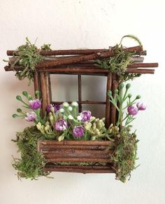 an old window with flowers and moss growing in it