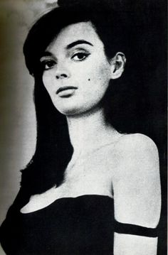 black and white photograph of a woman with long dark hair wearing a strapless top