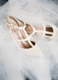 the bride's shoes are covered in white tulle