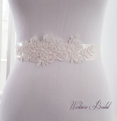 "This vintage inspired bridal sash is embellished with delicate floral lace for an elegant finish to your bridal attire. The sash is made with double faced Ivory satin ribbon 1.5\" wide and is 3 yards long. Beautiful addition to your wedding gown. PROCESSING: Please allow 3-5 business days for production. Also be sure to leave the date you require your order or your wedding date. For rush order, please convo us before placing your order. SHIPPING: Order will be shipped via USPS First Class Mail Fitted Lace Bridal Belt For Ceremony, Fitted Lace Bridal Belt For Bride, Lace Bridal Belt With Sashes For Wedding, Lace Bridal Belt For Ceremony, Cream Bridal Belt With Sashes For Wedding, Lace Bridal Belt With Lace Trim For Wedding, White Lace Bridal Belt For Ceremony, Fitted Embroidered Belt Sash For Wedding, White Lace Wedding Sash