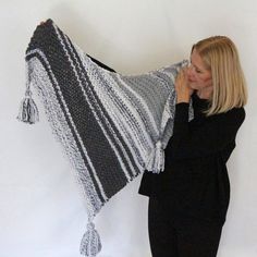 This is a gorgeous chunky triangle shawl in white and grey shades with three cute tassels. It's a versatile piece, you can wear as a shawl around your shoulders or as a scarf around your neck.  Measurements on a flat surface (there is a lot of stretch) 50" x 25" (127 x 63.5 cm) (without tassels) This grey and white chunky shawl is ready to ship. I handknit it with a soft blend of wool and acrylic in a smoke-free home.  In order to help your handmade shawl live a longer life, I recommend hand was Shawl Winter, Scarf Chunky, Grey Shades, Chunky Scarf, Triangle Shawl, Winter Shawl, Knit Shawl, Chunky Scarves, Triangle Shawls