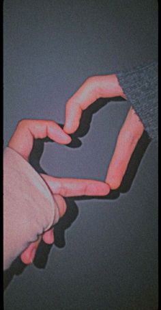 two hands making a heart shape with their fingers