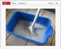 a mop in a blue bucket filled with water