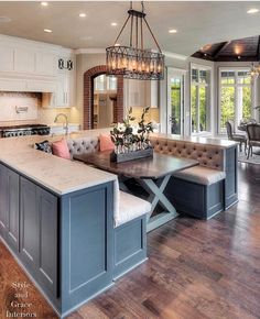 a large open concept kitchen and dining room with an island in front of the window