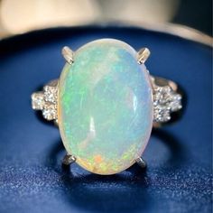 Genuine 7.2 CT Opal Stone + Diamonds White Platinum 900 Gold Ring US Sz 5.75 This opal is truly lit from within. Warm radiant XL genuine opal. Feels alive as it moves with the many layers of color and shifting lights. Truly a ring made for royalty! Item Condition: Unnoticeable scratches on the surface Main Material : Platinum Sub Color : Whites Ring Size : JPN 11, US 5.75 Total Main Stone(s) : Opal Main Stone Carat : 7.2ct Total Secondary Stone(s) : Diamond Secondary Stone Carat : 0.1ct Ring Material : Platinum Purity : Pt 900 Gross Weight : 7.5 g / 0.264 oz Diamond Color Grade : Unknown Cut Grade : Unknown Clarity Grade : Unknown Come with : Nothing 1ct Ring, Diamond Color Grade, Opal Stone, Opal Ring, Diamond Color, White Ring, Opal Rings, Diamond White, Colored Diamonds