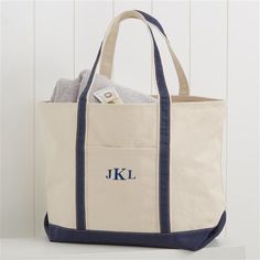 * Embroidered with any name or monogram in your choice of multiple thread colors, font and monogram options * Thread color shown in navy blue and font is Raised New Basic * Choose from 3 bag colors  * Quality crafted of 18 oz. heavy-weight natural canvas, making it durable for even the heaviest loads * Bag features outside and inside pockets with a key holder * Colored canvas accents at the base and handles keeping it neutral to coordinate with any outfit or occasion * Measures 22 L x 16 H x 7 D Ll Bean Tote, Monogram Beach Bag, Beach Bach, Totes Ideas, Wedding Extras, Monogram Luggage, Big Tote Bags, Bridesmaid Tote Bags, Fall Break