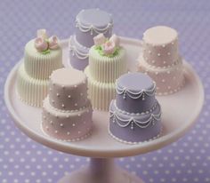 there are many small cakes on the cake plate