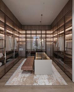 a large walk in closet with glass doors