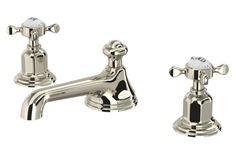 two chrome faucets with black handles and white knobs on each side, one is