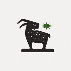 a black and white drawing of a rabbit holding a green leaf