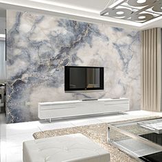 a living room with marble walls and white furniture