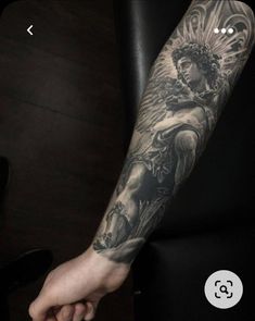 a person with a tattoo on their arm holding the hand of another person's arm