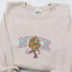 a white sweatshirt with the word nice on it and a cartoon character holding a dog