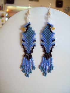 a pair of blue and black beaded bird earrings