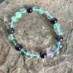 This bracelet is made with high-quality Fluorite and Amethyst stones which bring stability, protection, and awareness to the wearer. Zodiac Sign: Fluorite - Pisces / Amethyst - Aquarius, Pisces, Aries, Scorpio, SagittariusChakra: Fluorite - Heart & Third Eye / Amethyst - Third Eye & ThroatBirthstone: Amethyst - February Fluorite is a highly protective and stabilizing stone which is perfect for grounding and harmonizing spiritual energy. It can aid in increasing one's intuitive abilities and deve Spiritual Fluorite Crystal Bracelet For Healing, Holistic Amethyst Beaded Bracelets For Healing, Fluorite Natural Stones Crystals For Healing, Spiritual Fluorite Bracelets With Natural Stones, Spiritual Fluorite Bracelets For Healing, Spiritual Fluorite Bracelet For Healing, Spiritual Healing Fluorite Bracelet, Spiritual Fluorite Bracelets With Gemstone Beads, Amethyst Beaded Bracelets For Healing With Natural Stones