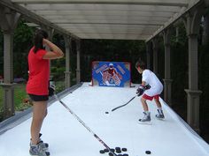 two people playing ice hockey on an outdoor rink